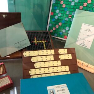 Shows scrabble letters saying welcome to the Sight for Surrey Centenary Exhibition and other exhibits on display at the exhibition 