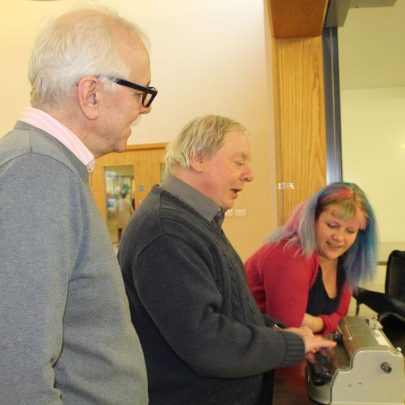 Image shows a Braille machine being used