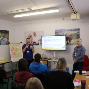 Image shows members of staff from the charity presenting to attendees to the workshop.