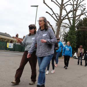 Image shows a group of people participating in sighted guide training.