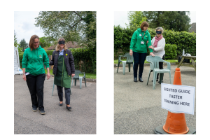Image shows: staff from Sensory Services by Sight for Surrey teaching people how to guide a blind person through a series of obstacles in an outside environment.