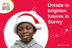 Image shows: Christian wearing a Santa hat smiling, the image is surrounded by a bauble shape and has writing to the right saying Donate to brighten futures in Surrey.