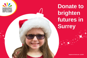 Image shows a young girl with long hair, tinted glasses and wearing a Santa hat, her image is surrounded by a bauble shape and the words 'Donate to brighten futures in Surrey' is sitting on the right.