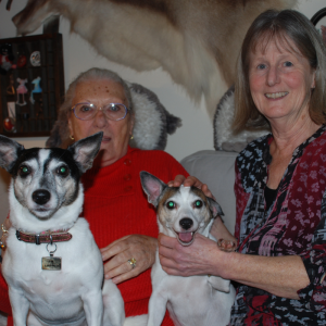 Image shows Birte and Helen sitting together with Birte's two Jack Russell dogs. 