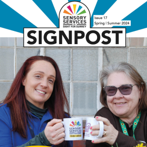 Front cover of Signpost Spring Summer 2024. Image shows two ladies holding mugs clinking them together they are both smiling at the camera.