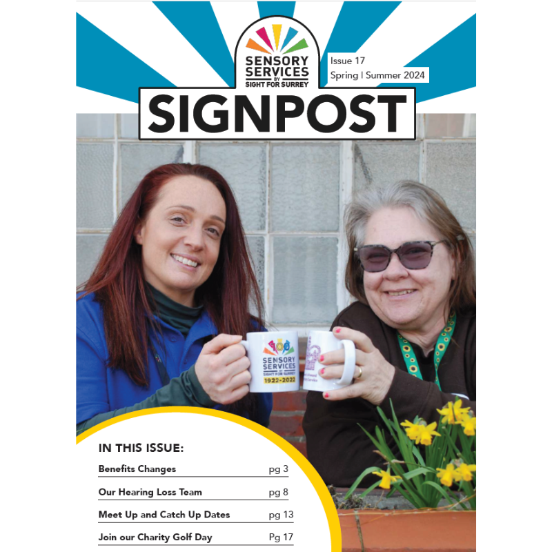 Front cover of Signpost Spring Summer 2024 showing Natalie, Community Champion, and Yola, a lady supported by the charity. They are both holding mugs and clinking them together in a cheers pose.