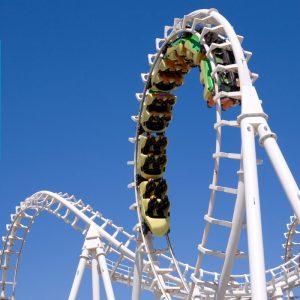 Image shows a roller coaster set against a blue sky.