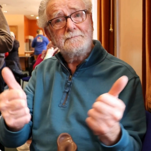 A man is giving the thumbs up in British Sign Language