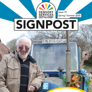 Front cover of Signpost Spring Summer 2025 showing Roy leaning up against a tractor at Bocketts Farm