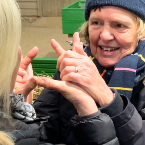A lady using Deafblind Manual communication.