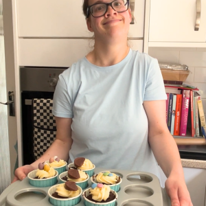 Lucy proudly showing a selection of her cupcakes 