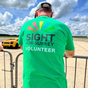 A volunteer from the charity wearing a t-shirt with the words volunteer on the back.