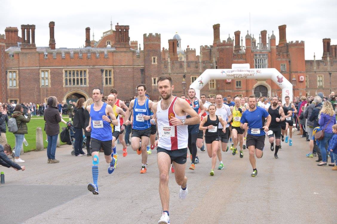 The start of Hampton Court Palace Half Marathon, a group of runners are setting off running.