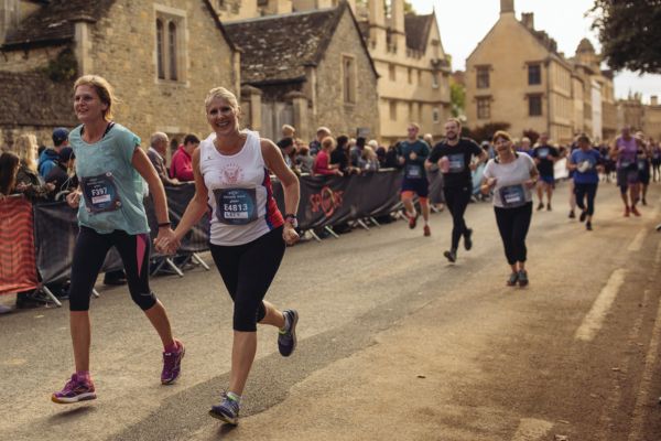 Two ladies are running together 