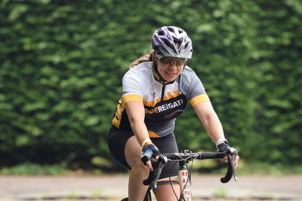A lady is cycling on her bike in the Ride Reigate race.