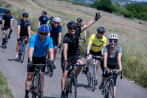 The start of Hampton Court Palace Half Marathon, a group of runners are setting off running.