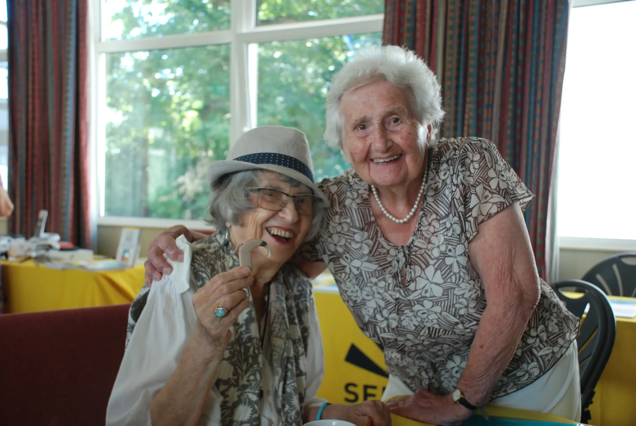 Two elderly ladies at one of our community hubs