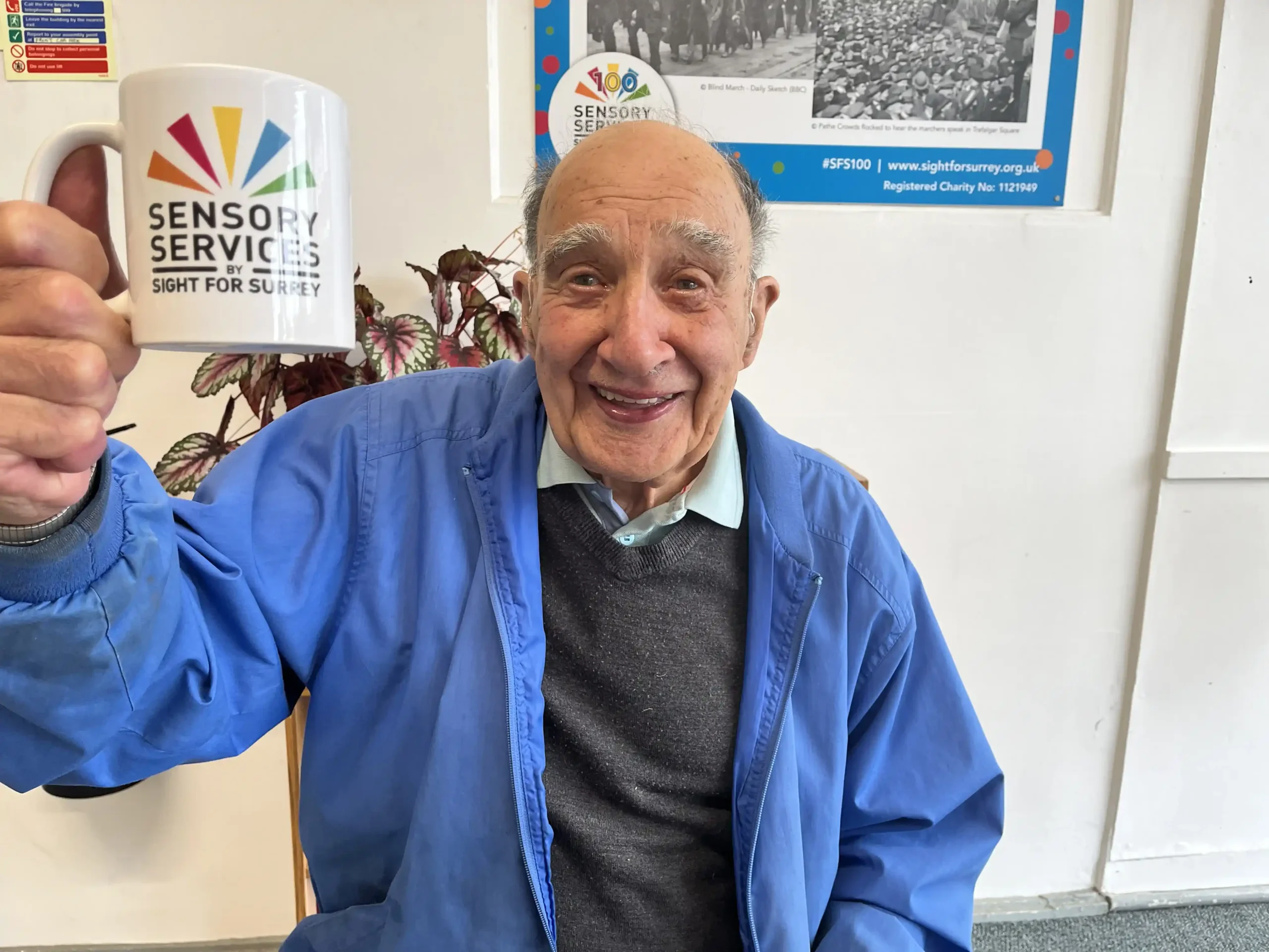 Reg holding a mug at one of our Community Hubs
