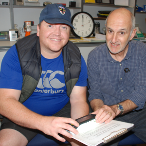 Tony showing a visitor to the Resource Centre a selection of sight loss support equipment 