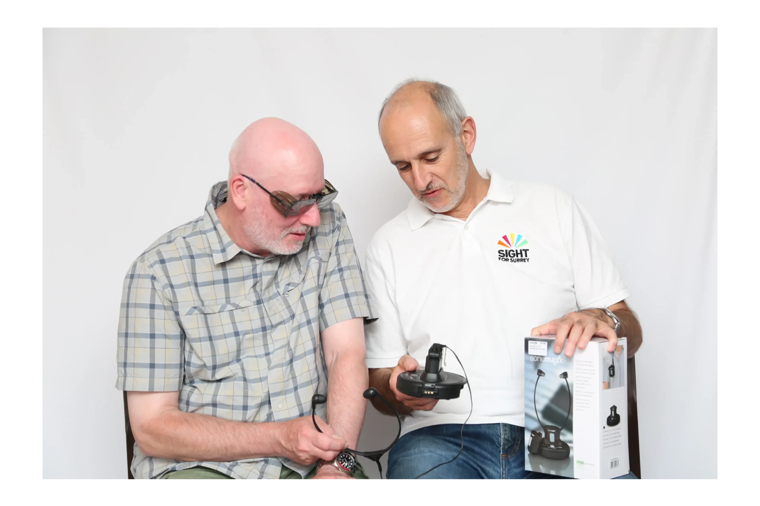 A man being shown hearing loss equipment.