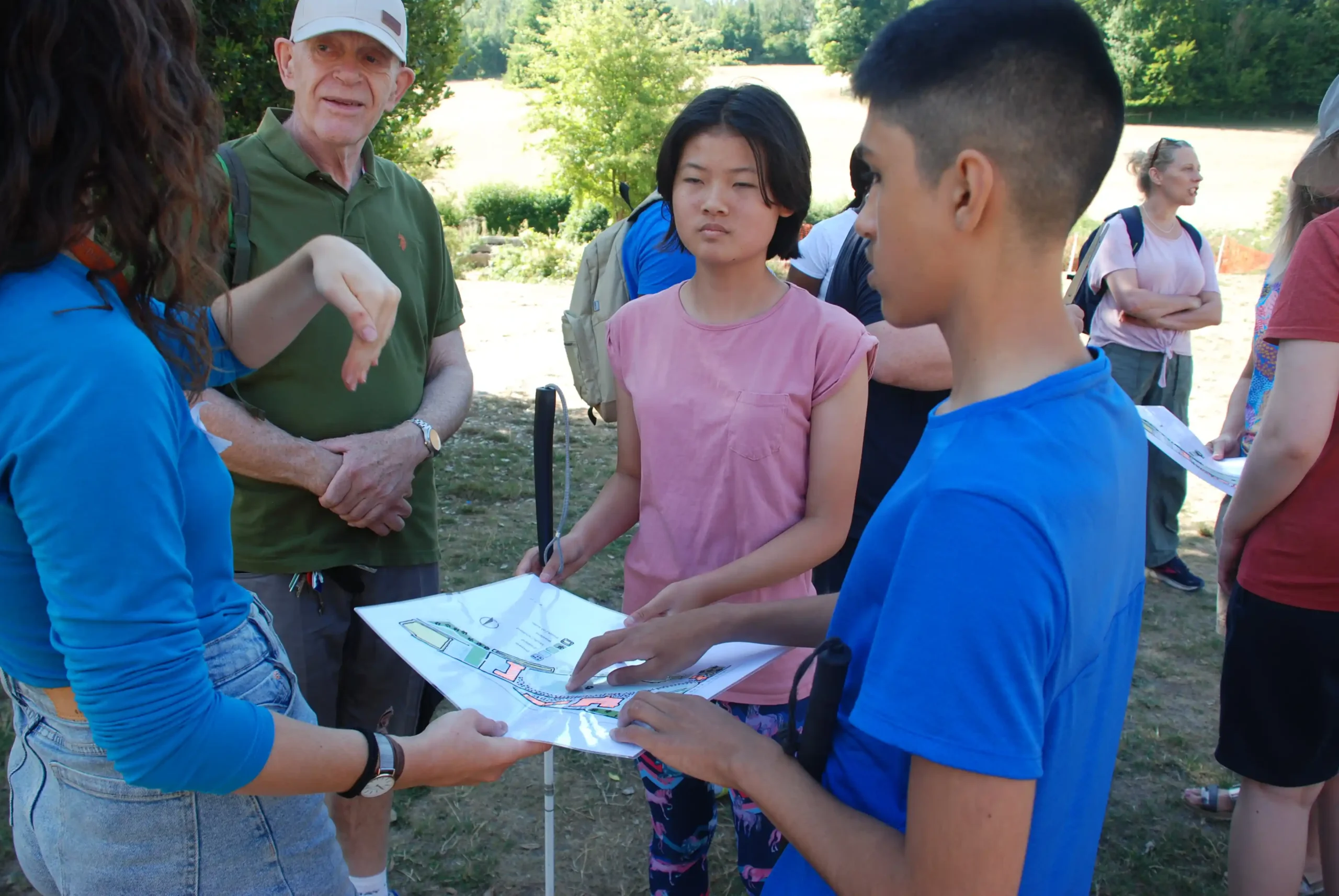 Some young people we support at our Residential Weekend away on a treasure hunt using a tactile map to navigate their way.