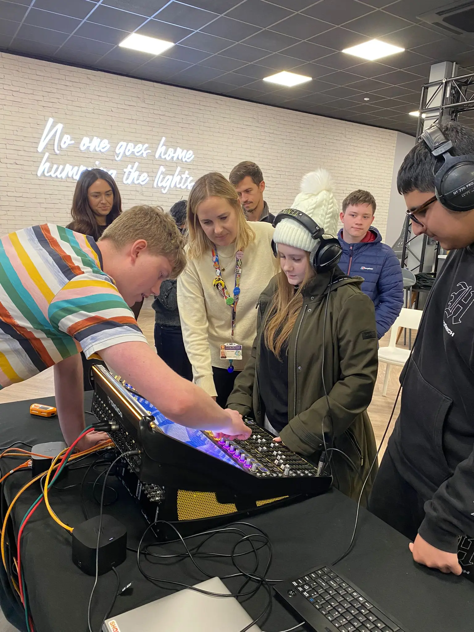 A group of young people we support trying out some new mixing equipment at DiGiCo.