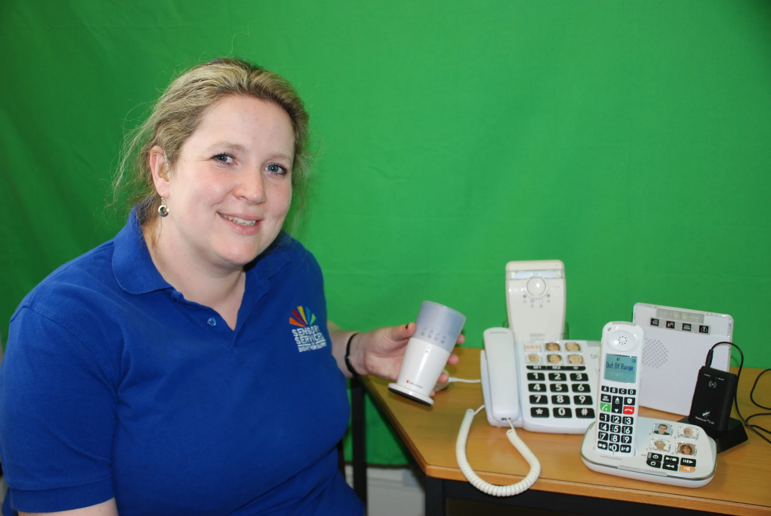 Rachel, Hearing Loss Advisor, showing some of the equipment we can provide.