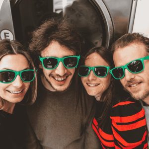 A group of young people wearing sunglasses
