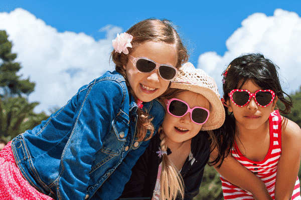 Three children are all wearing sunglasses