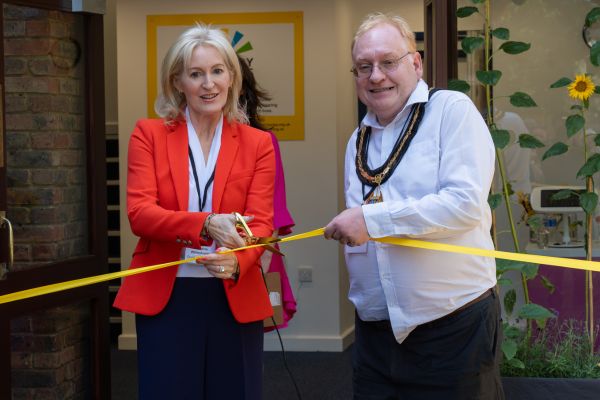 Christine Wilmshurst, Chair of Trustees and Tim Hall, Chair of Surrey County Council cutting the ribbon officially marking Bridgehead House, Ashtead open.