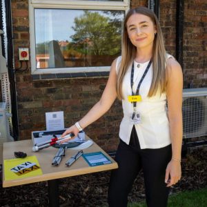 Evie, Trainee Rehab Support Worker, showcasing some equipment.