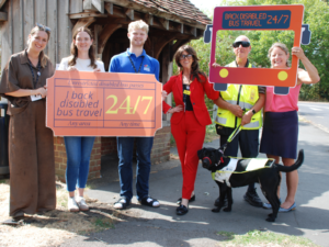 Celebrating free disabled travel from left to right, Jess, Carmel, Clare Burgess, CEO of Sensory Services by Sight for Surrey, Brian and Helen Maguire MP