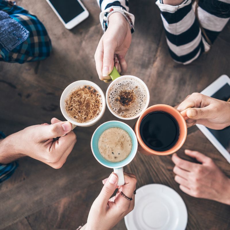 People holding tea and coffee in mugs