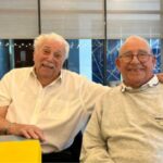 Two men smiling