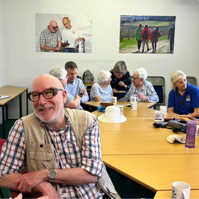 Group of people talking and smiling around a table