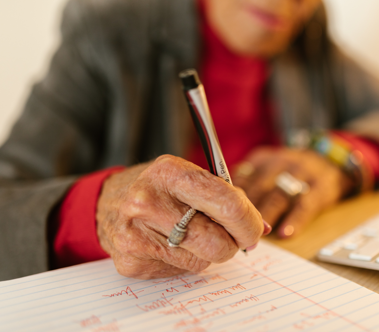 An elderly lady is writing her Will