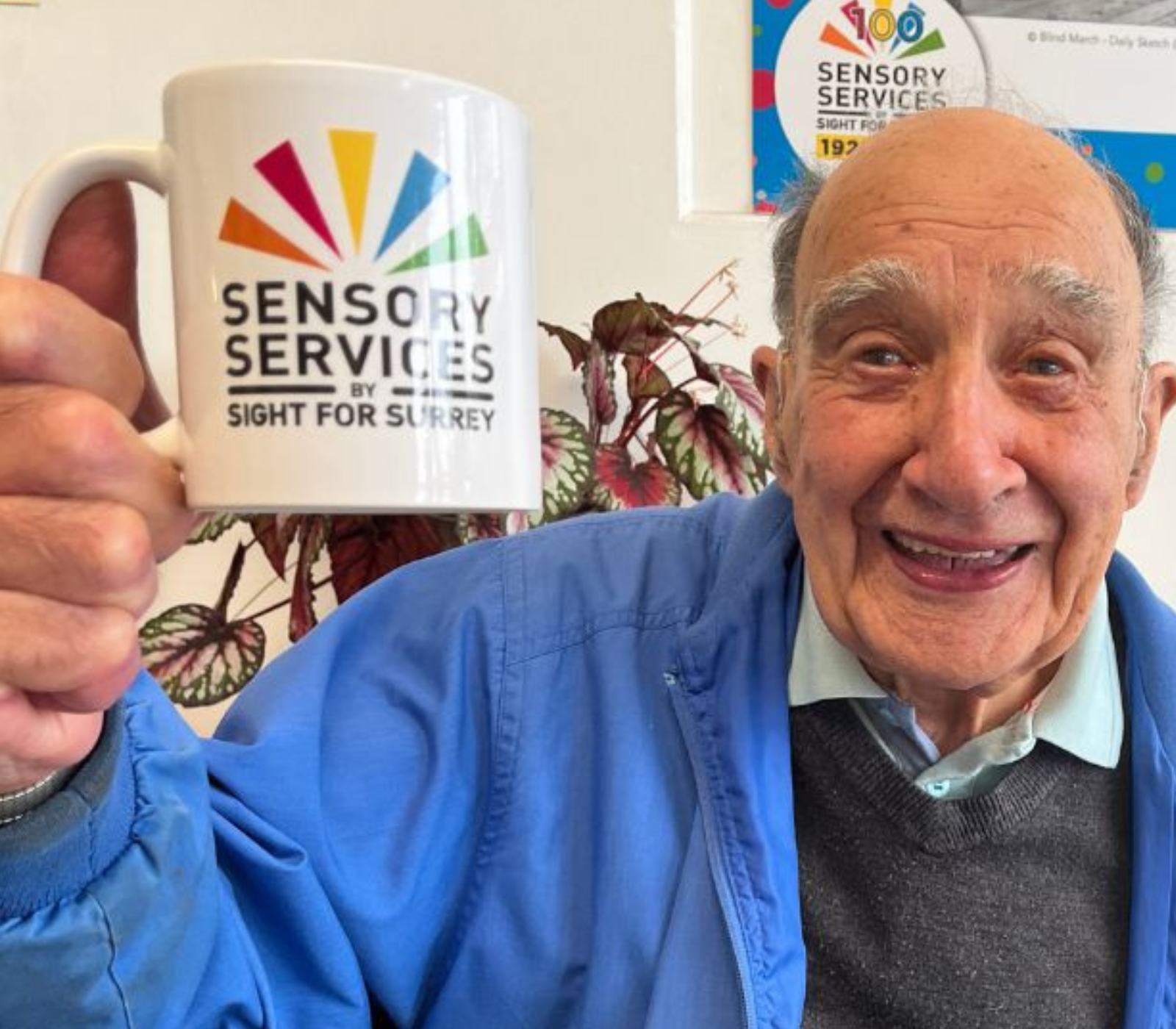 Reg an attendee is our Community Hub holding a mug of tea